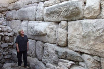 Dr Eilat Mazar poses beside the wall which she claims was built by Solomon.