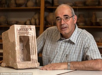Dr Garfinkel with a stone shrine
