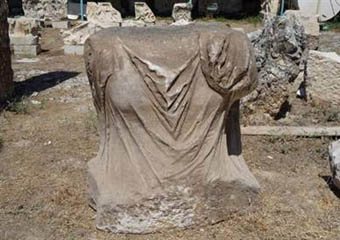 The torso of the newly discovered statue of Apollo. The drapery appears to conceal an impressive bust.