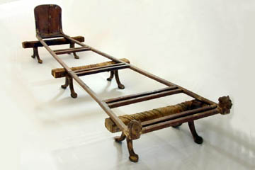 The reassembled bed. The head of the bed is towards the right and the upright piece is at the foot. Note how the bed is wider at one end.